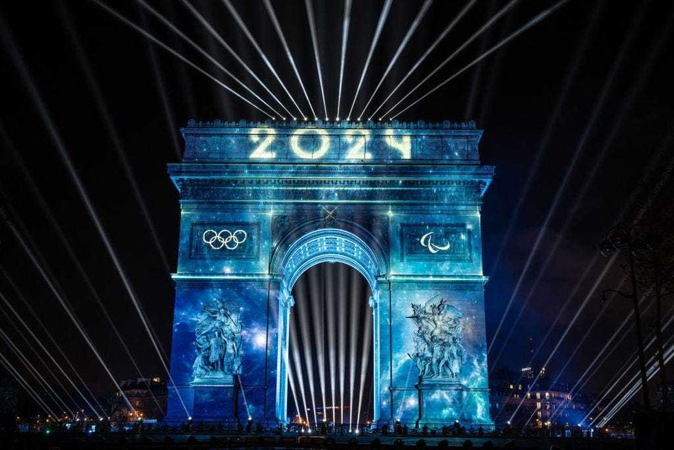 This photograph taken in Paris, on December 31, 2023, shows the Arc de Triomphe illuminated with Olympic rings for the New Year celebrations.