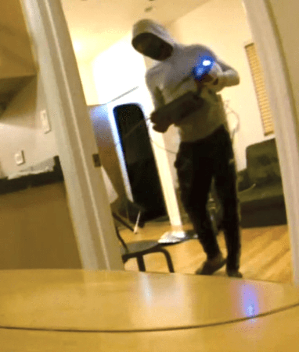 This screenshot from a security camera reportedly shows Derrick Patterson using a stun gun during a robbery in October 202, the FBI alleged.