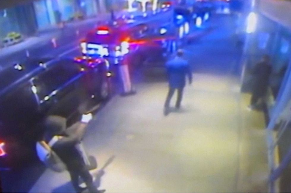 This still image from surveillance video obtained by the Associated Press shows the suspect, left, sought in the the killing of UnitedHealthcare CEO Brian Thompson, center, outside a Manhattan hotel where the health insurer was holding an investor conference, Wednesday, Dec. 4, 2024