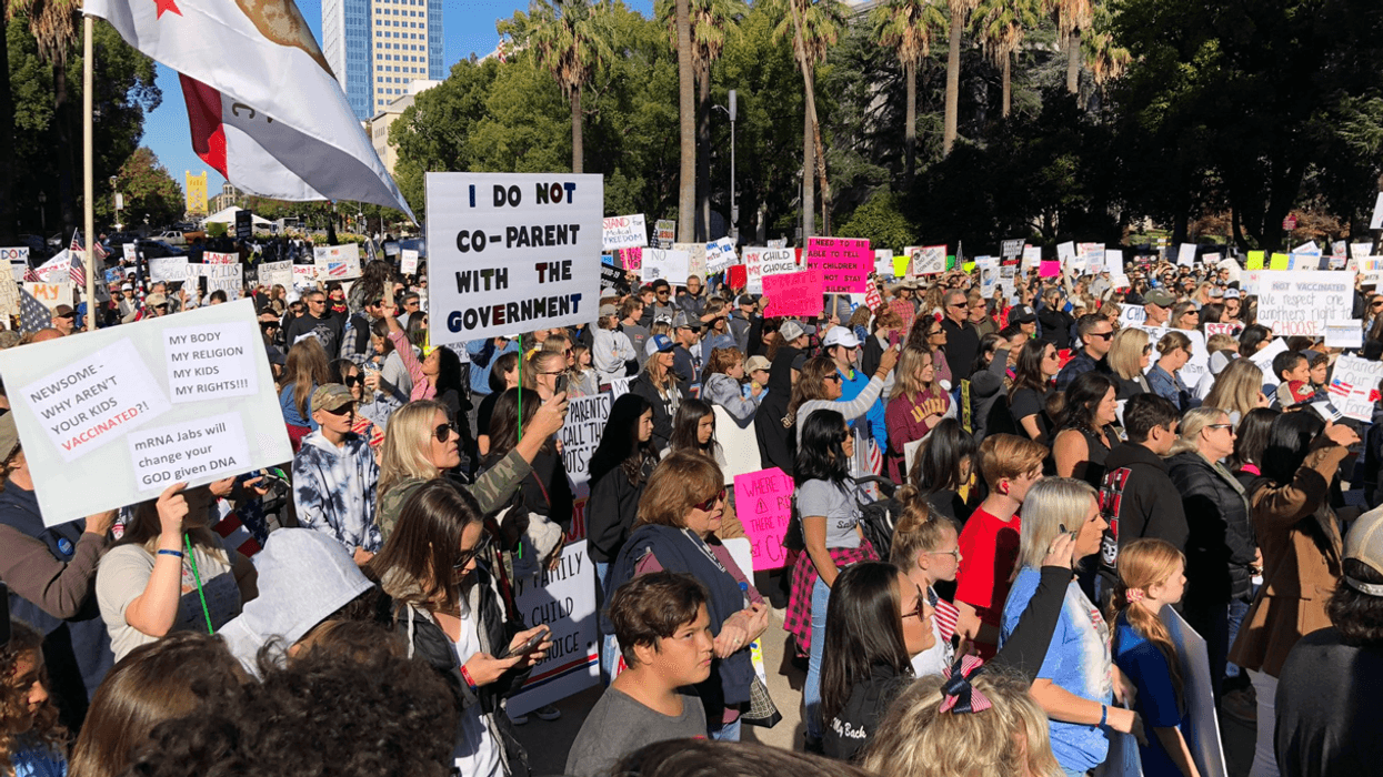 Thousands rally outside the California State Capitol against the state's COVID-19 vaccine mandate for students.