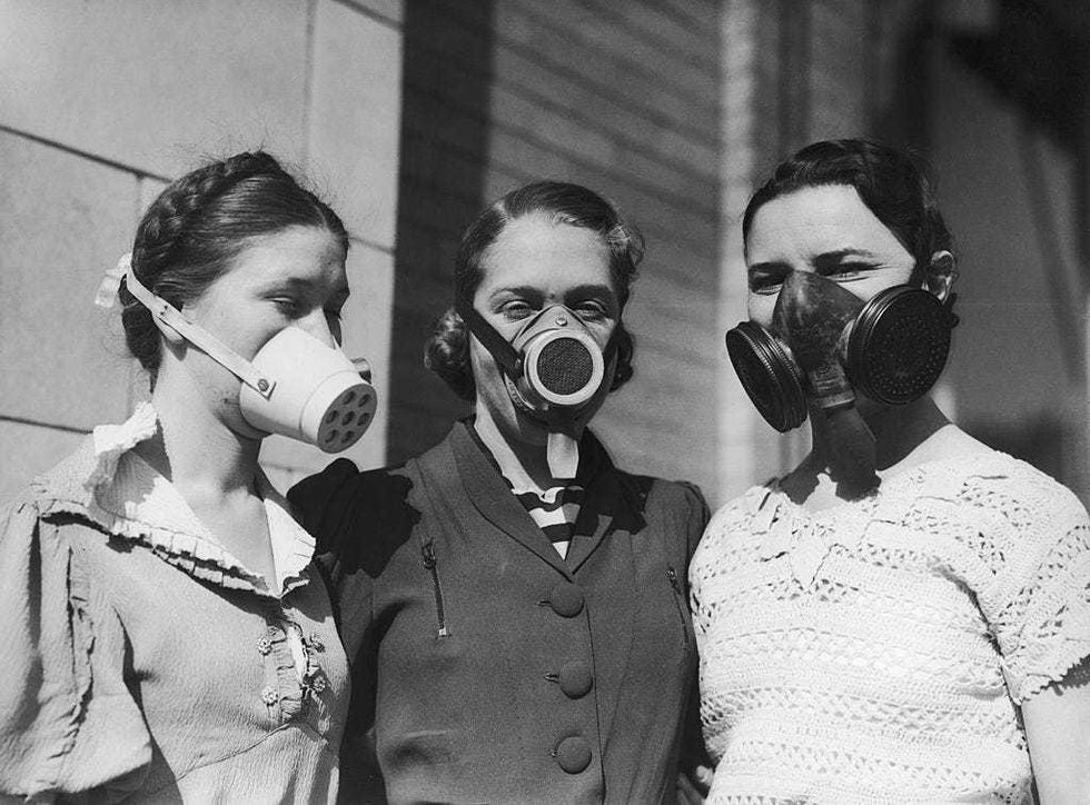 Three girls modelling various dustbowl masks to be worn in areas where the amount of dust in the air causes breathing difficulties, circa 1935.