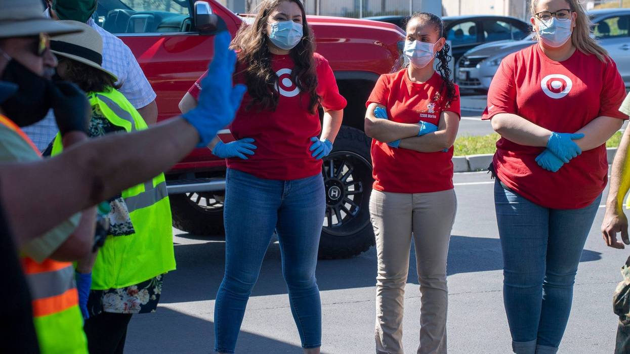 Three Target employees wear face masks and gloves for the South County Food Distribution in Soledad, Calif, event on Friday, April 24, 2020.