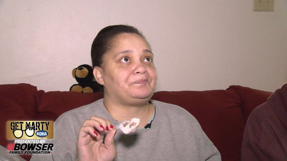 Tiffany France shows the prosthetic that replaced the roof of her mouth after surgery to remove her tumor.