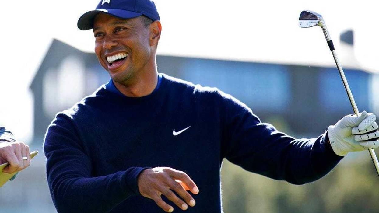 Tiger Woods smiles after hitting his tee shot on the 16th hole during the Genesis Invitational pro-am golf event at Riviera Country Club, Wednesday, Feb. 12, 2020, in the Pacific Palisades area of Los Angeles.