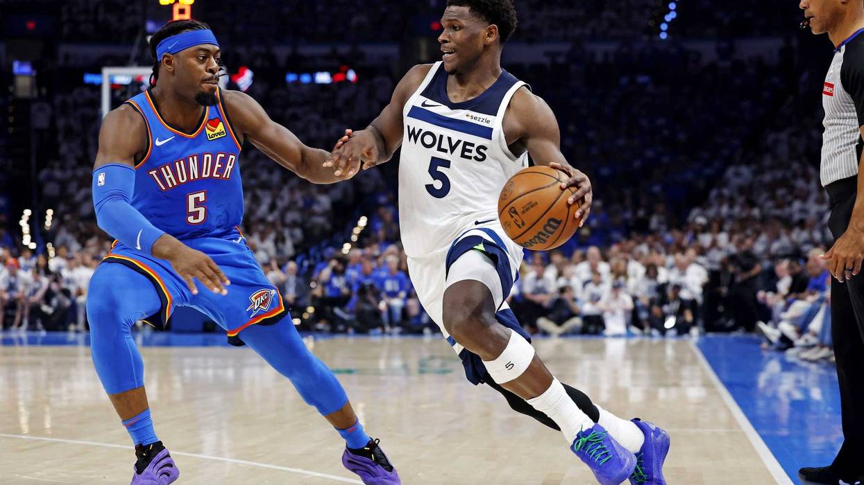 Timberwolves guard Anthony Edwards (5) drives to the basket against Oklahoma City Thunder guard Luguentz Dort (5) during the second quarter in game five of the western conference finals for the 2025 NBA Playoffs at Paycom Center.