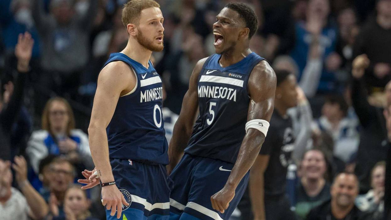 Timberwolves guard Donte DiVincenzo (0) and Minnesota Timberwolves guard Anthony Edwards (5) celebrate after a shot is made against the Charlotte Hornets in the second half at Target Center.