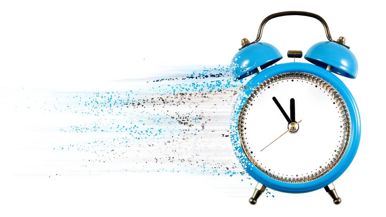 Time flows swiftly as a blue alarm clock dissolves into vibrant fragments against a clear background