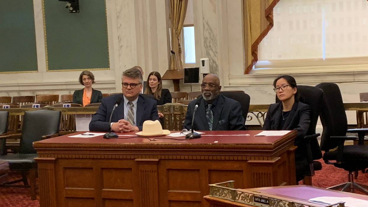 Timothy Calhoun (center), flanked by Michael Froehlich of Community Legal Services and Lucy Qui of Senior Law Center, fell victim to an MV Realty mortgage scam.