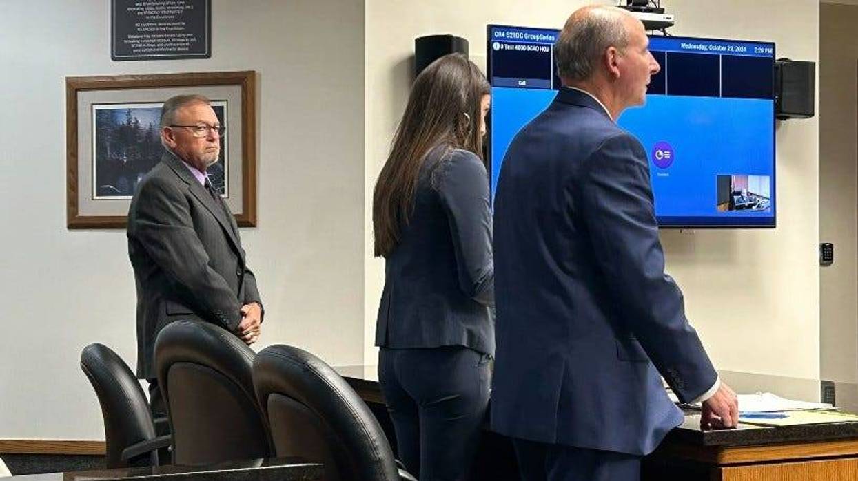 Timothy Daugherty, left, appears in an Oakland County courtroom, alongside his attorneys.
