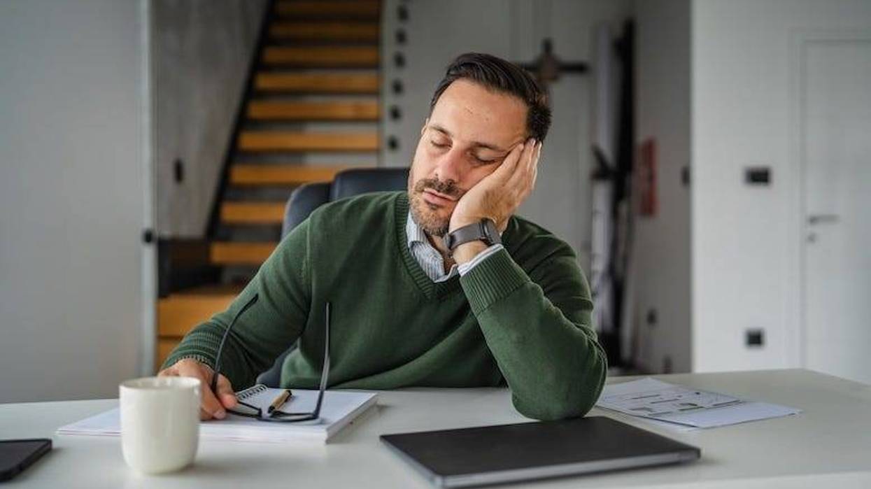 Tired businessman sleeping at his desk