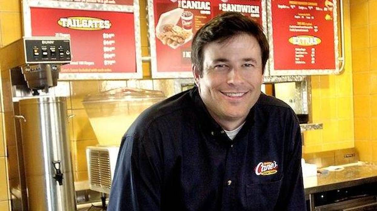 Todd Graves, founder of Raising Canes, poses for a photo inside the restaurant