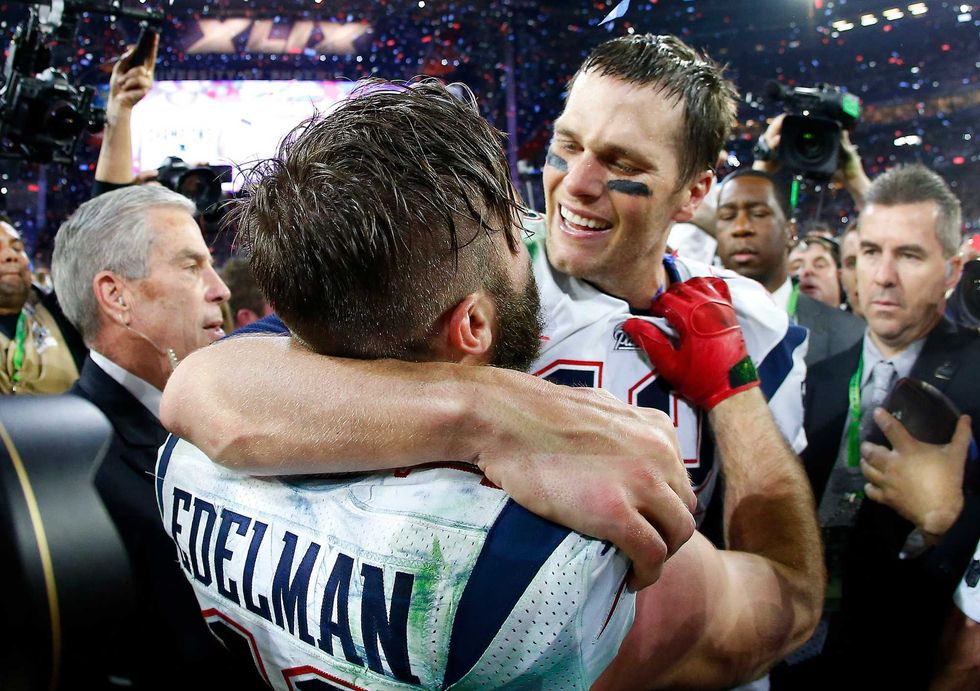 Tom Brady #12 and Julian Edelman #11 of the New England Patriots celebrate after defeating the Seattle Seahawks 28-24 to win Super Bowl XLIX at University of Phoenix Stadium on February 1, 2015 in Glendale, Arizona.