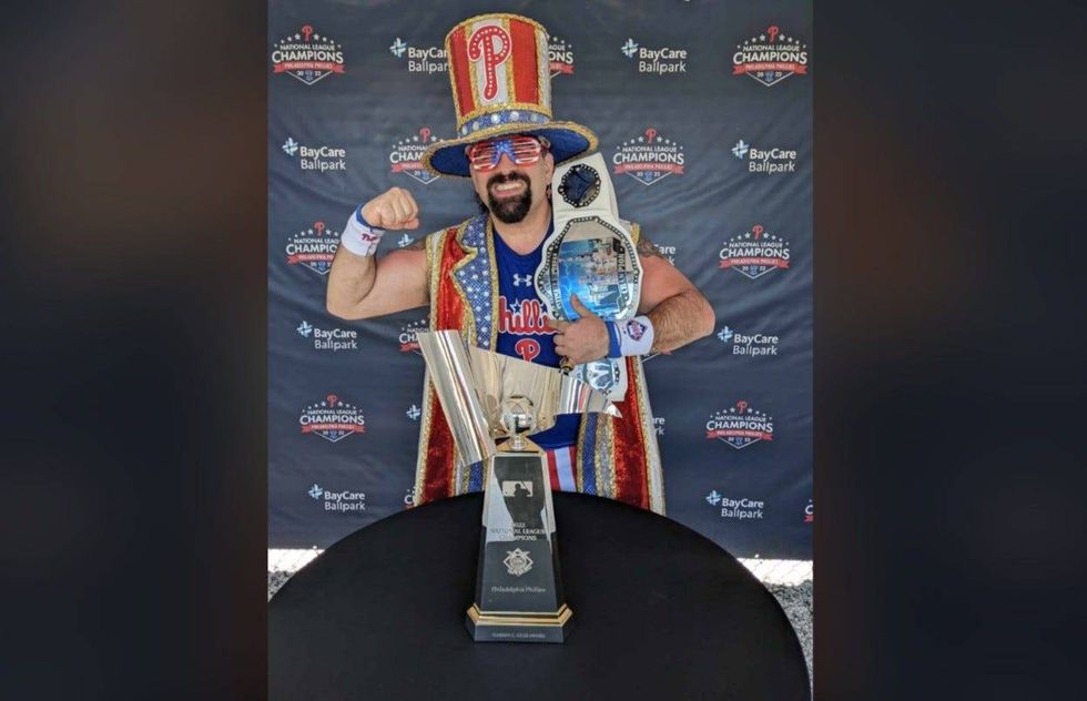 Tony poses in his "Tornado" costume with the National League Championship trophy.