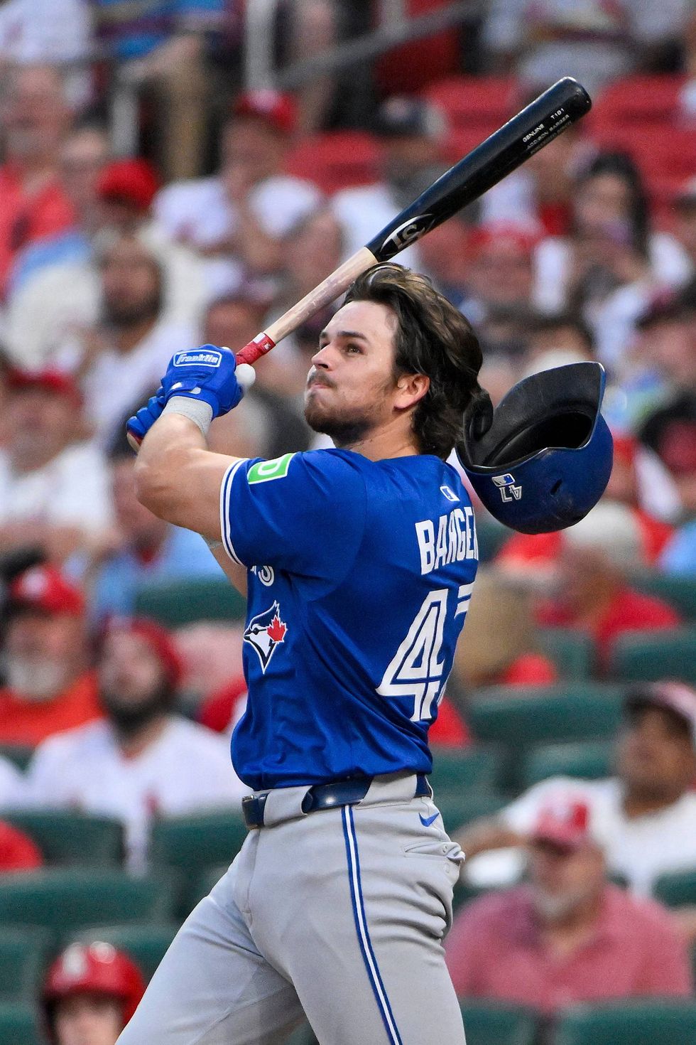 Toronto Blue Jays third baseman Addison Barger (47) loses his helmet as he hits a one run double against the St. Louis Cardinals during the fifth inning at Busch Stadium.