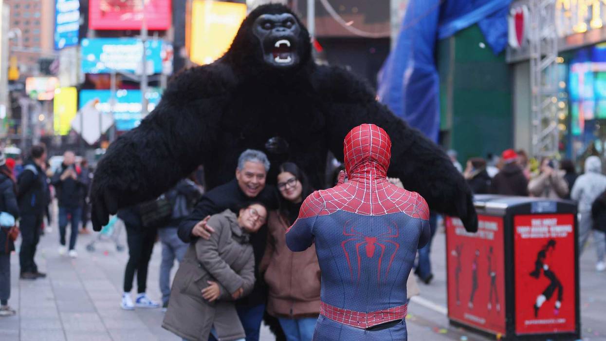 Tourists pose for photos in Times Square this year