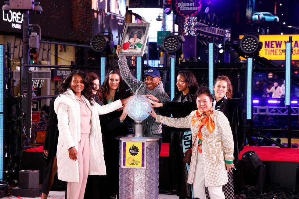 Tracey Collins, Eric Adams, and members of Gotham FC wait for the ball to drop during New Year