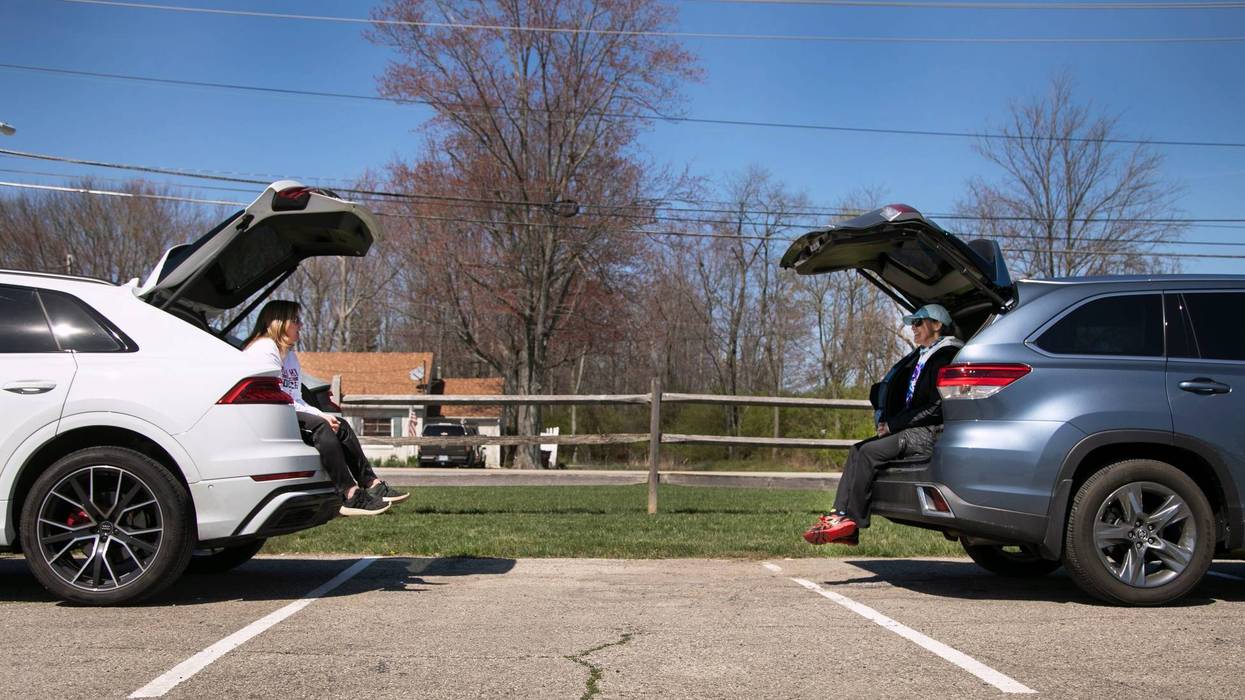 Traci Zins, left, of Indian Hill, and good friend Melissa Jessup, of West Chester, visit while social distancing at Summit Park in Blue Ash, Thursday, April 2, 2020. The pair were careful to talk from their cars. With the new coronavirus pandemic raging,