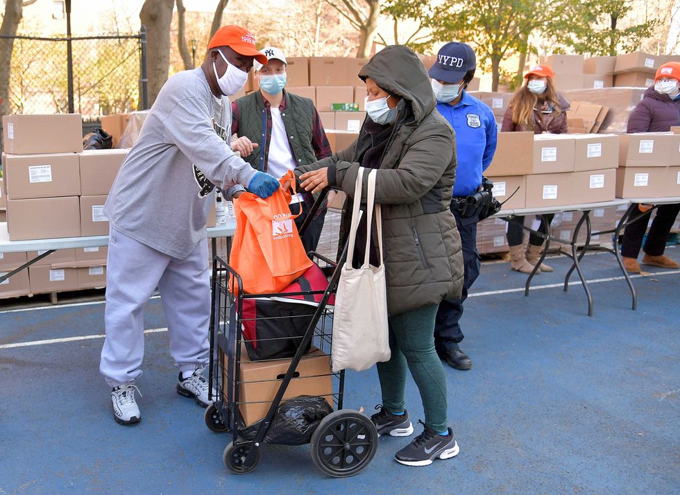 Tracy Morgan (L), Food Bank For New York City, and Council Member Robert E. Cornegy Jr. distribute turkeys to Brooklyn families in celebration of Thanksgiving on November 21, 2020 in Brooklyn, New York.