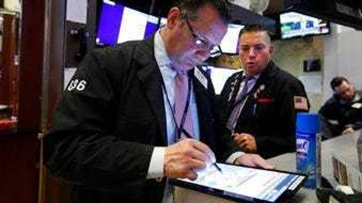 Traders Edward Curran, left, and Jonathan Mueller work on the floor of the New York Stock Exchange, Thursday, March 12, 2020. (AP Photo/Richard Drew)