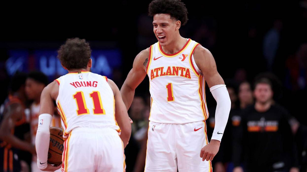 Trae Young of the Atlanta Hawks celebrates the win with teammate Jalen Johnson after a game against the New York Knicks.