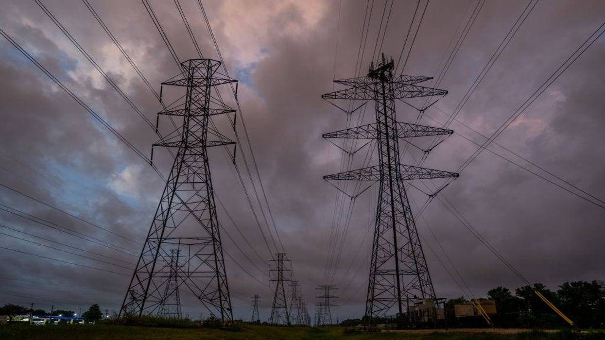 Transmission towers are seen near the CenterPoint Energy power plant on July 11, 2022 in Houston, Texas. ERCOT (Electric Reliability Council of Texas) is urging Texans to voluntarily conserve power today, due to extreme heat potentially causing rolling blackouts.