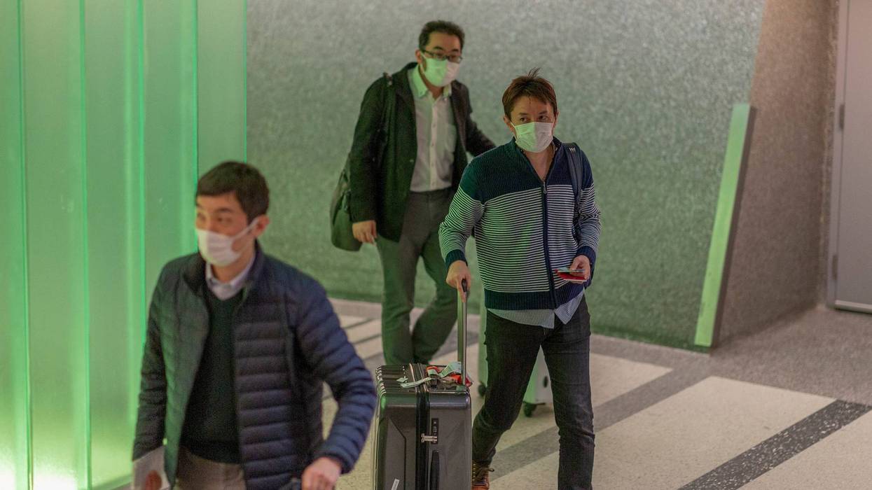 Travelers arrive to LAX Tom Bradley International Terminal wearing medical masks for protection against the novel coronavirus outbreak on February 2, 2020 in Los Angeles.