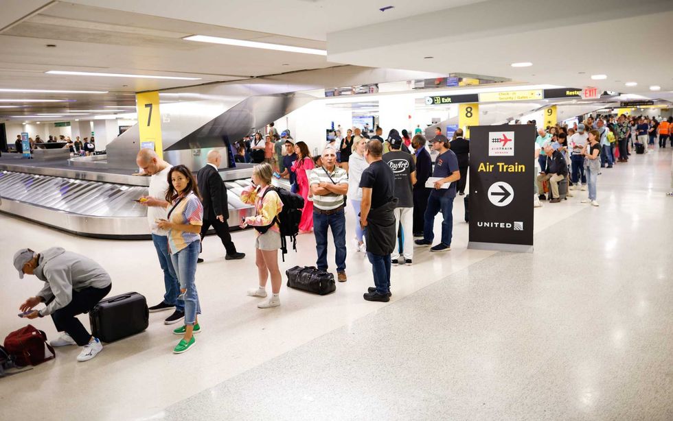 Travelers assemble and await the rescheduling of their flights at Newark International Airport on June 27, 2023 in Newark