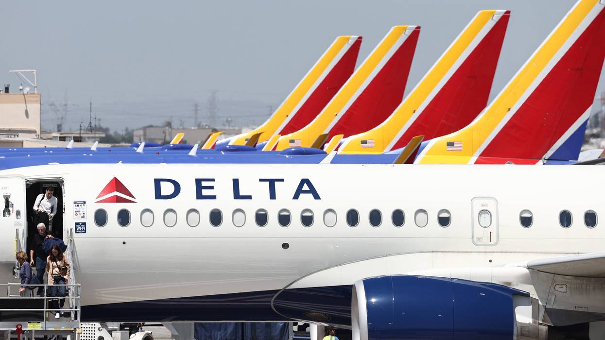 Travelers disembark from a Delta Air Lines flight with Southwest Airlines planes in the background at Hollywood Burbank Airport on July 25, 2024 in Burbank, California.