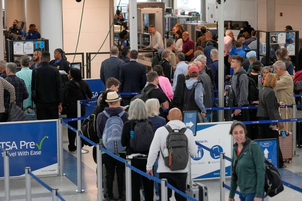 Travelers make their way through security at Newark Liberty International Airport in Newark, N.J., Monday, May 5, 2025.