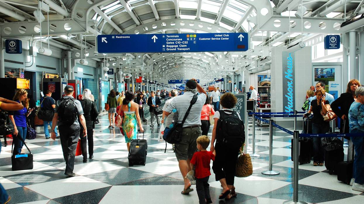 Travelers rushing through the airport to make their flights