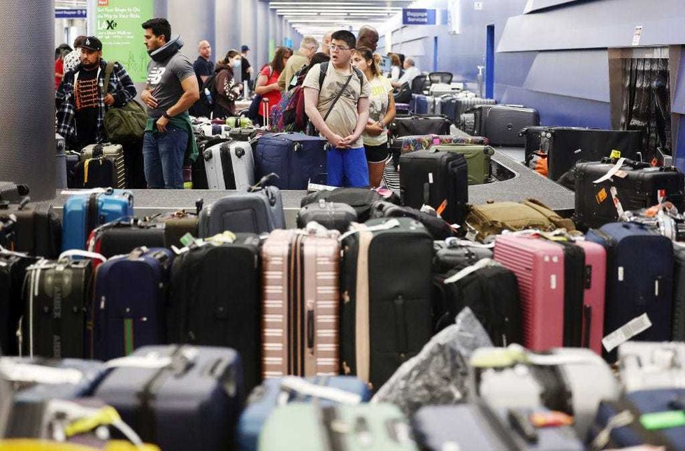 Travelers wait for their bags amid rows of unclaimed luggage at the United Airlines baggage claim area at Los Angeles International Airport (LAX) on June 29, 2023 in Los Angeles, California. United Airlines cancelled hundreds of flights again today amid a chaotic week of flight cancellations and delays amid weather issues and strong traveler demand. United Airlines has cancelled nearly 3,000 flights since June 24th as the July 4th holiday travel rush nears. (Photo by Mario Tama/Getty Images)