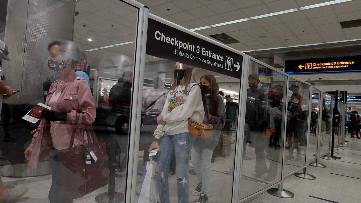 Travelers wait in line at the TSA checkpoint in the Miami International Airport before starting the Labor Day weekend on September 03, 2021 in Miami, Florida.