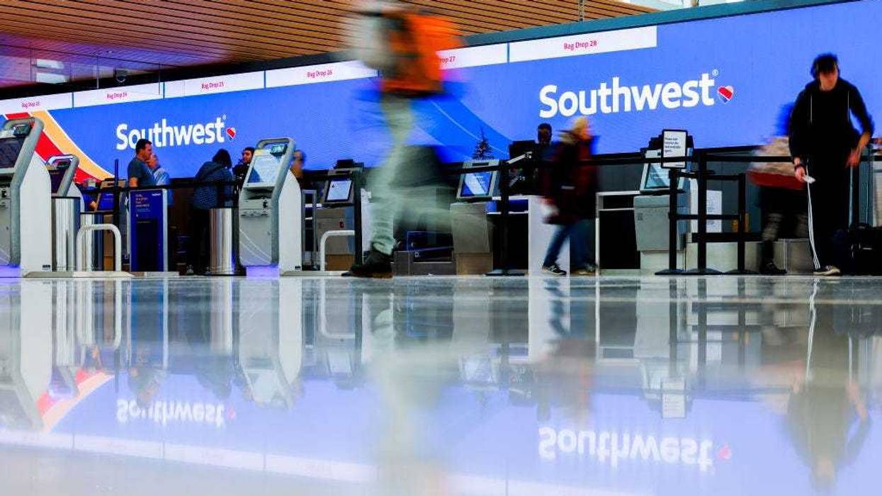 Travelers walk past the Southwest Airlines check-in counter at Denver International Airport on December 28, 2022 in Denver, Colorado.