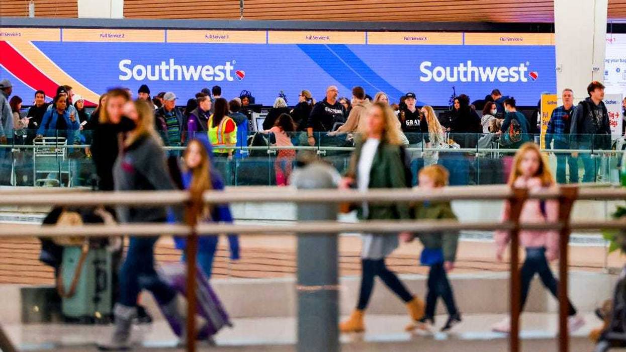 Travelers walk past the Southwest Airlines check-in counter at Denver International Airport on December 28, 2022 in Denver, Colorado.