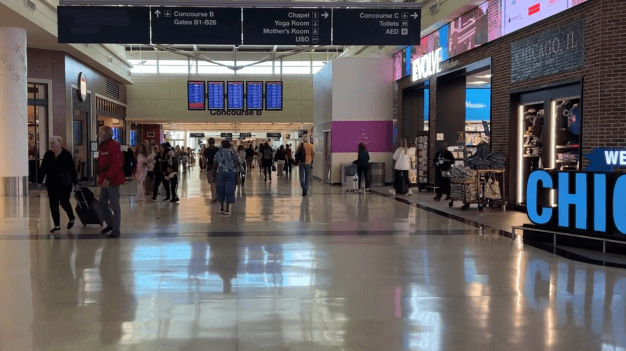 Travelers walk through Midway International Airport in Chicago.