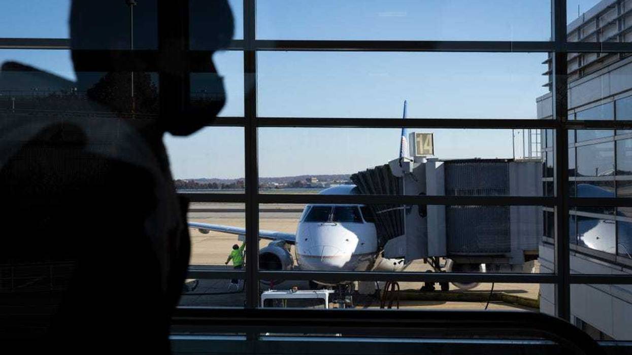 Travelers walk through Terminal A at Ronald Reagan Washington National Airport November 23, 2021 in Arlington, Virginia.