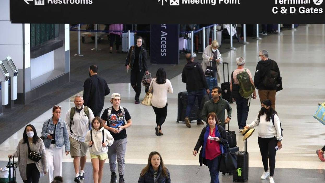 Travelers walk with their luggage at San Francisco International Airport on July 01, 2022 in San Francisco, California.