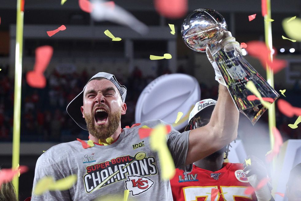 Travis Kelce hoists the Lombardi Trophy following the Chiefs