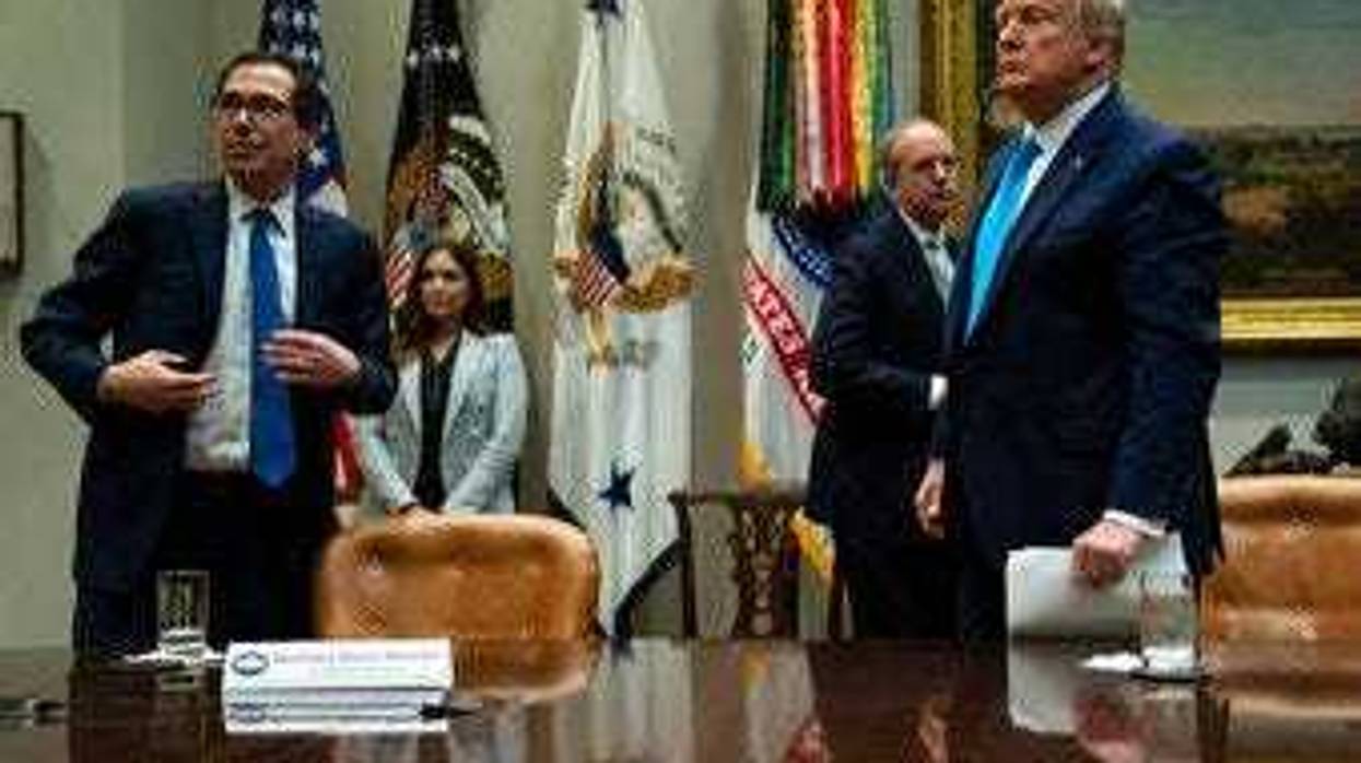Treasury Secretary Steven Mnuchin and President Donald Trump listen to a question during a conference call with banks on efforts to help small businesses during the coronavirus pandemic. (AP Photo/Evan Vucci)