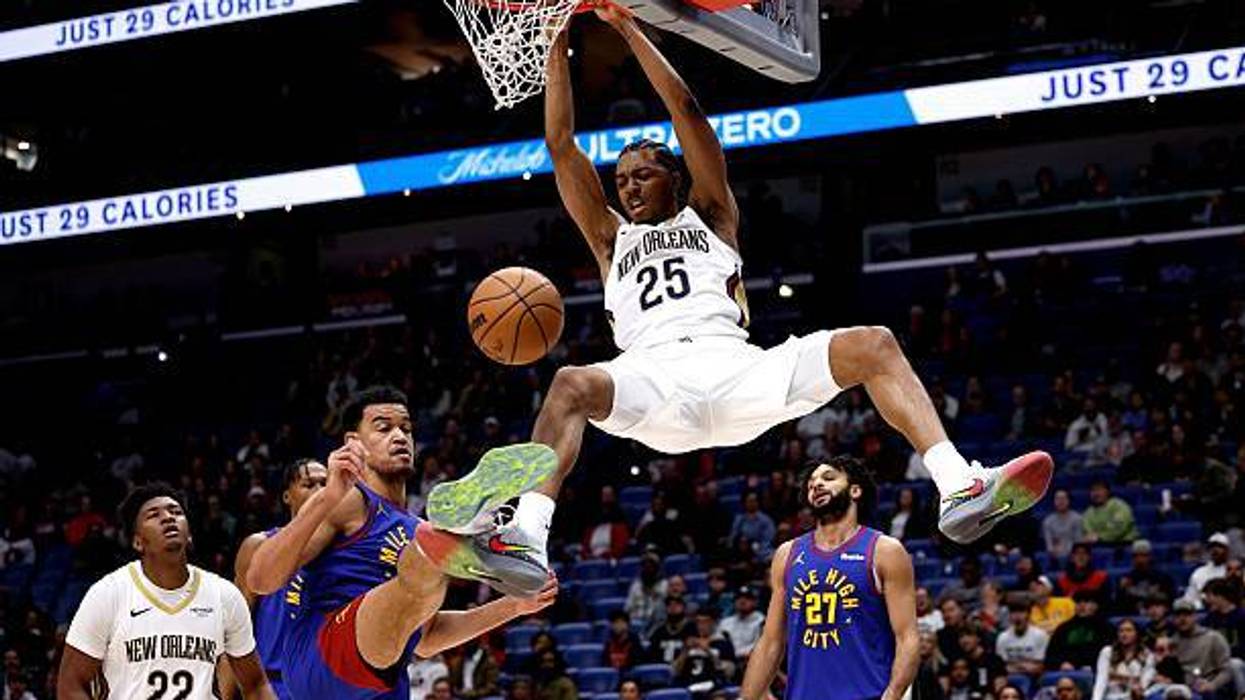 Trey Murphy III #25 of the New Orleans Pelicans dunks over Spencer Jones