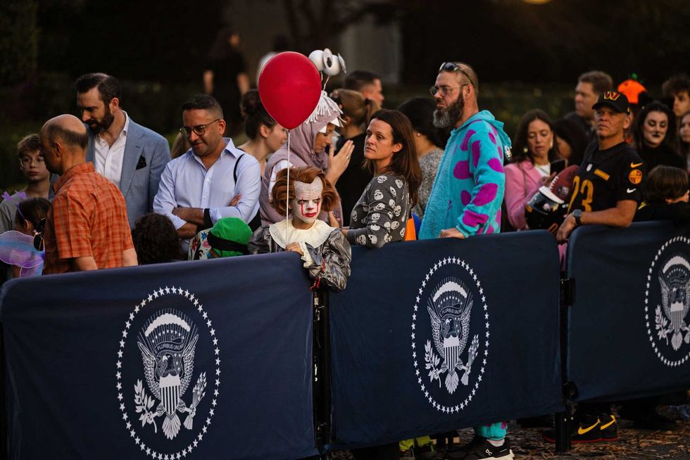 Trick-or-treaters wait in line at the event