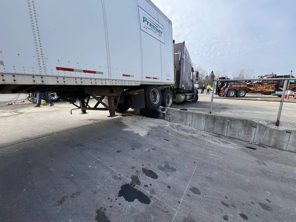 Truck hits concrete abutment