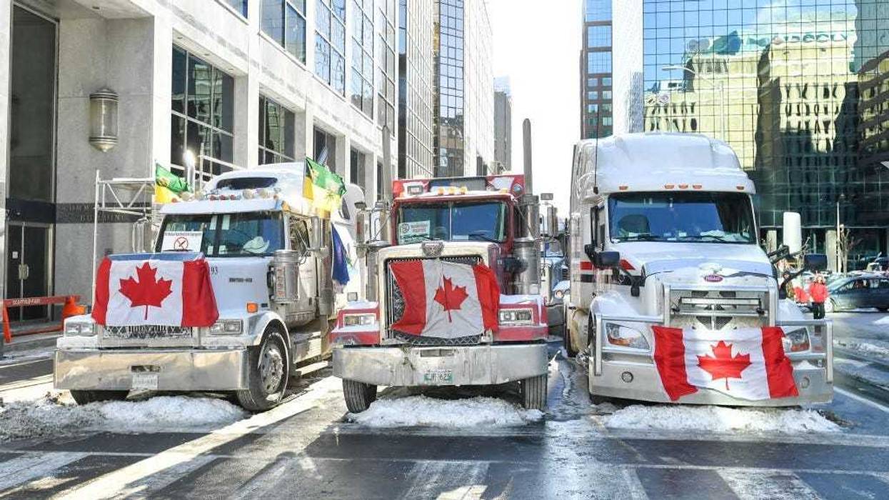Truckers lineup their trucks on Metcalfe Street as they honk their horns on February 5, 2022 in Ottawa, Canada.