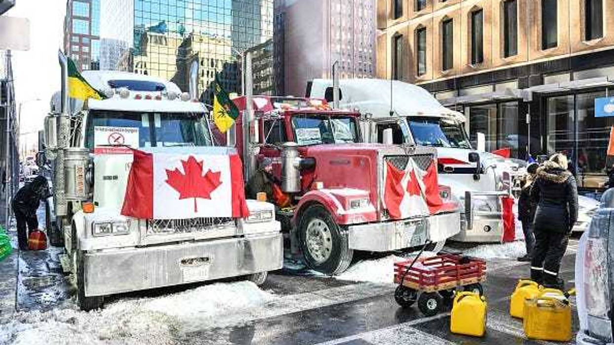 Truckers refuel their trucks in the cold during the Freedom Convoy truck protest on February 5, 2022 in Ottawa, Canada.