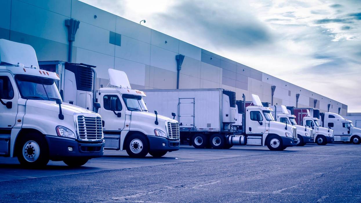 Trucks loading unloading at warehouse