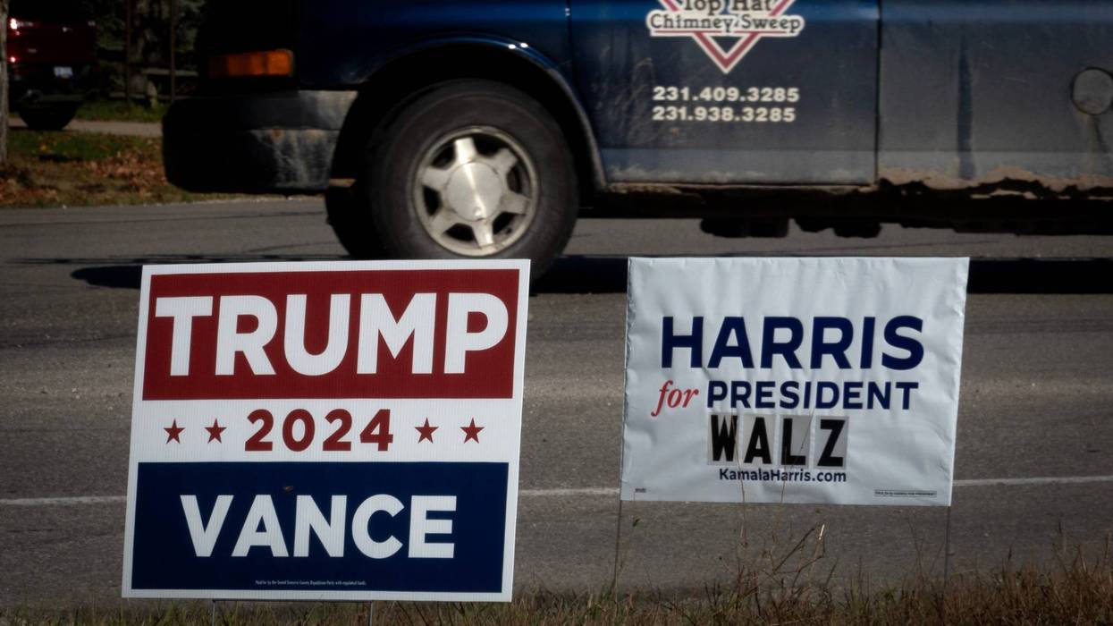 trump and harris signs along road