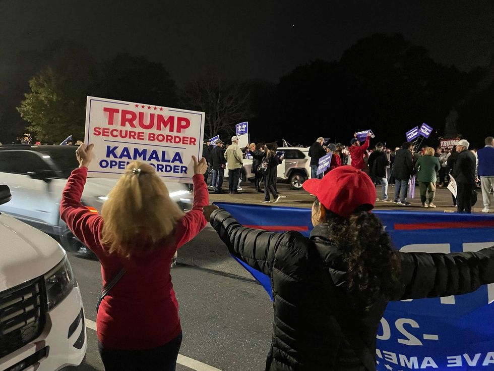 Trump supporters held signs and banners and cheered as drivers honked their horns.