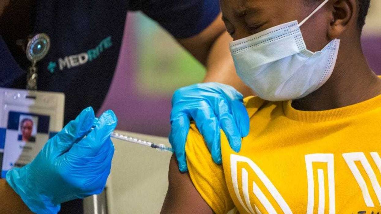 Tse Cowan, 8, winces as he is administered the coronavirus (COVID-19) vaccine at a vaccination pop-up site at P.S. 19 on November 08, 2021 in the Lower East Side in New York City.
