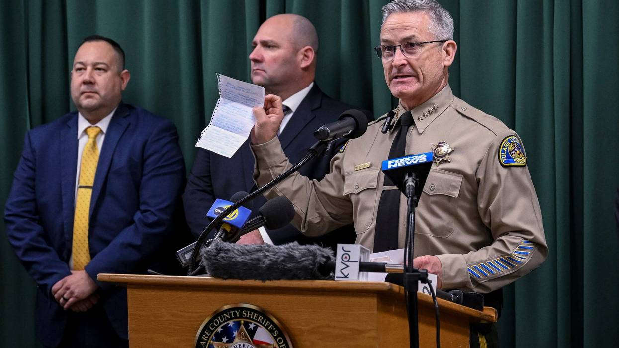 Tulare County Sheriff Mike Boudreaux holds a letter Monday, Jan. 30, 2023, from a Maine woman that sent $100 to add to the reward offered for information about a mass shooting that occurred January 16, in Goshen, Calif. No arrests were announced but autopsies confirmed that all six victims died from gunshot wounds.