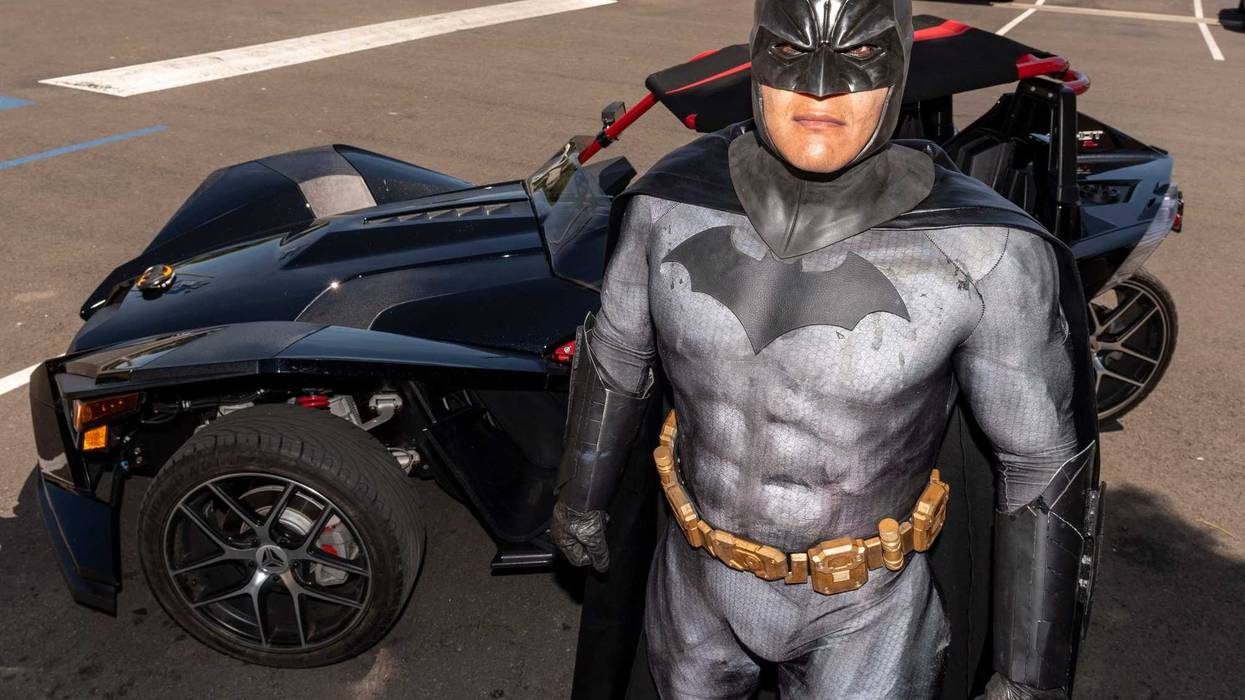 Tulare Police officers escort Batman (Detective Art Cabello) through the streets of Tulare on Monday, April 27, 2020.
